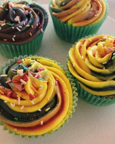 Cupcakes caseros hechos por la Pilareta con una decoración de arcoíris.
